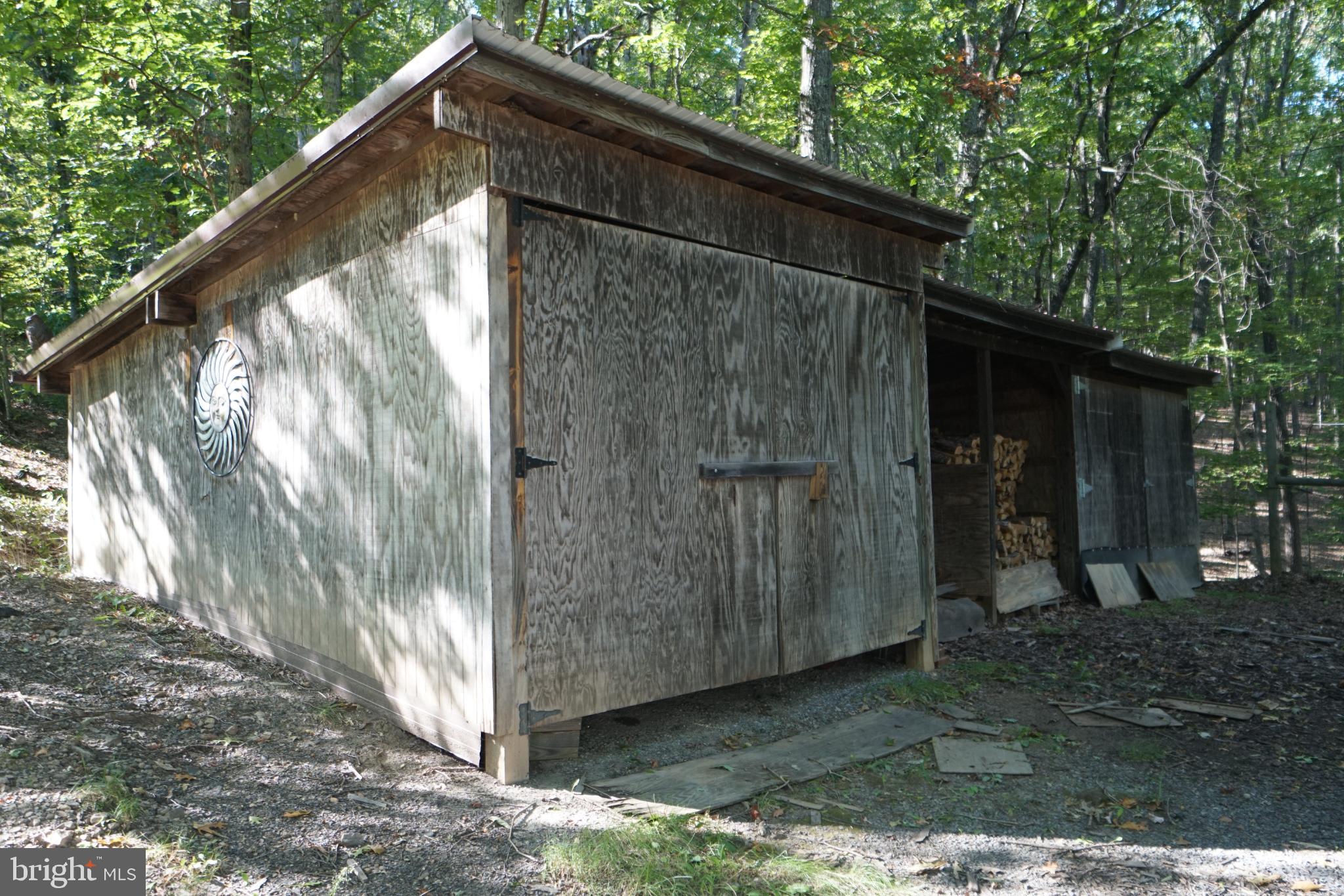 1537 Hidden Valley Road Franklin, WV 26807 - Photo 72 of 78 Rustic shed nestled in a serene forest.