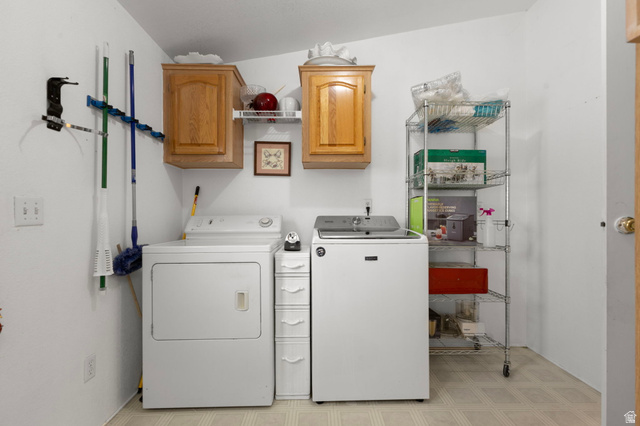2600 North Hill Field Road, Unit 134 Layton, UT 84041 - Photo 15 of 41 Laundry room with light flooring, washer and clothes dryer, and cabinet space
