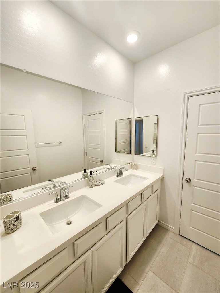 7308 North Decatur Boulevard, Unit 4 North Las Vegas, NV 89084 - Photo 14 of 34 Full bathroom featuring double vanity and tile patterned floors