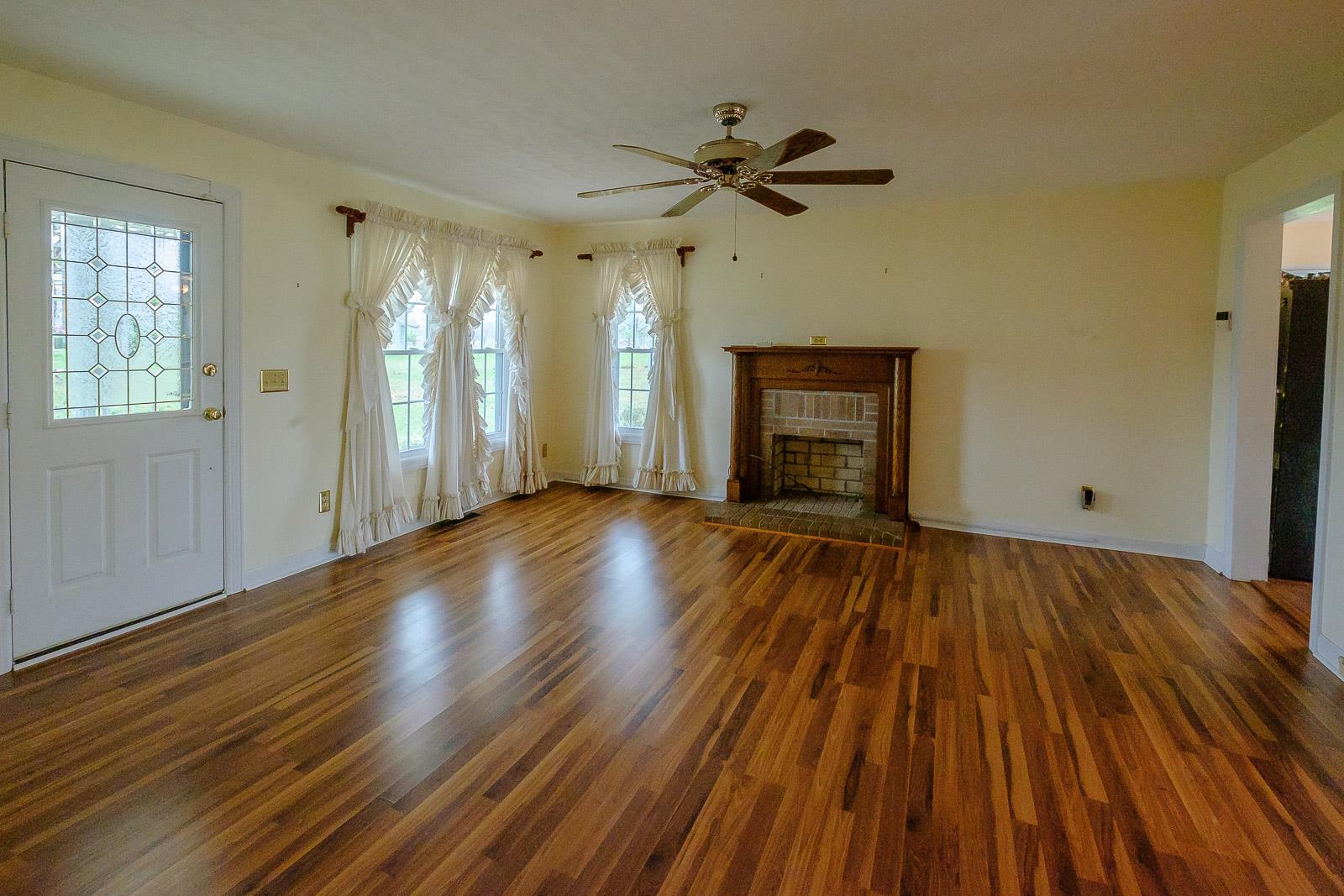 900 Red Boiling Springs Road Lafayette, TN 37083 - Photo 11 of 30 a view of an empty room with wooden floor and a window