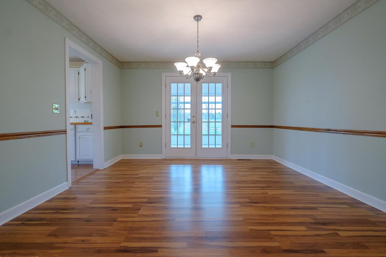 900 Red Boiling Springs Road Lafayette, TN 37083 - Photo 16 of 30 a view of an empty room with wooden floor and a window