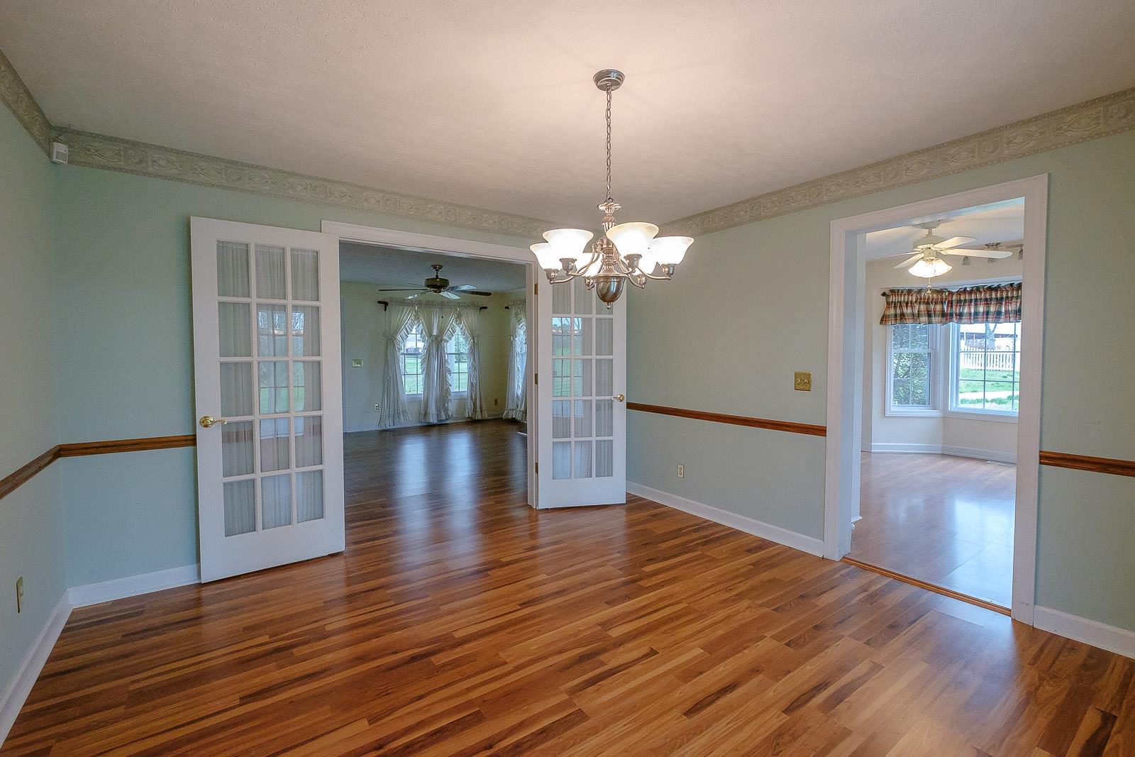 900 Red Boiling Springs Road Lafayette, TN 37083 - Photo 17 of 30 a view of a livingroom with wooden floor chandelier and stairs