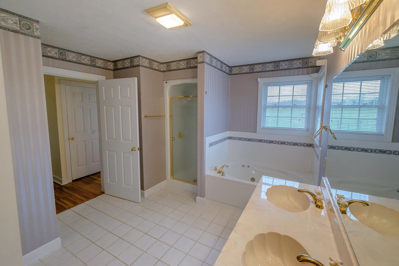 900 Red Boiling Springs Road Lafayette, TN 37083 - Photo 23 of 30 a bathroom with a tub shower and a sink