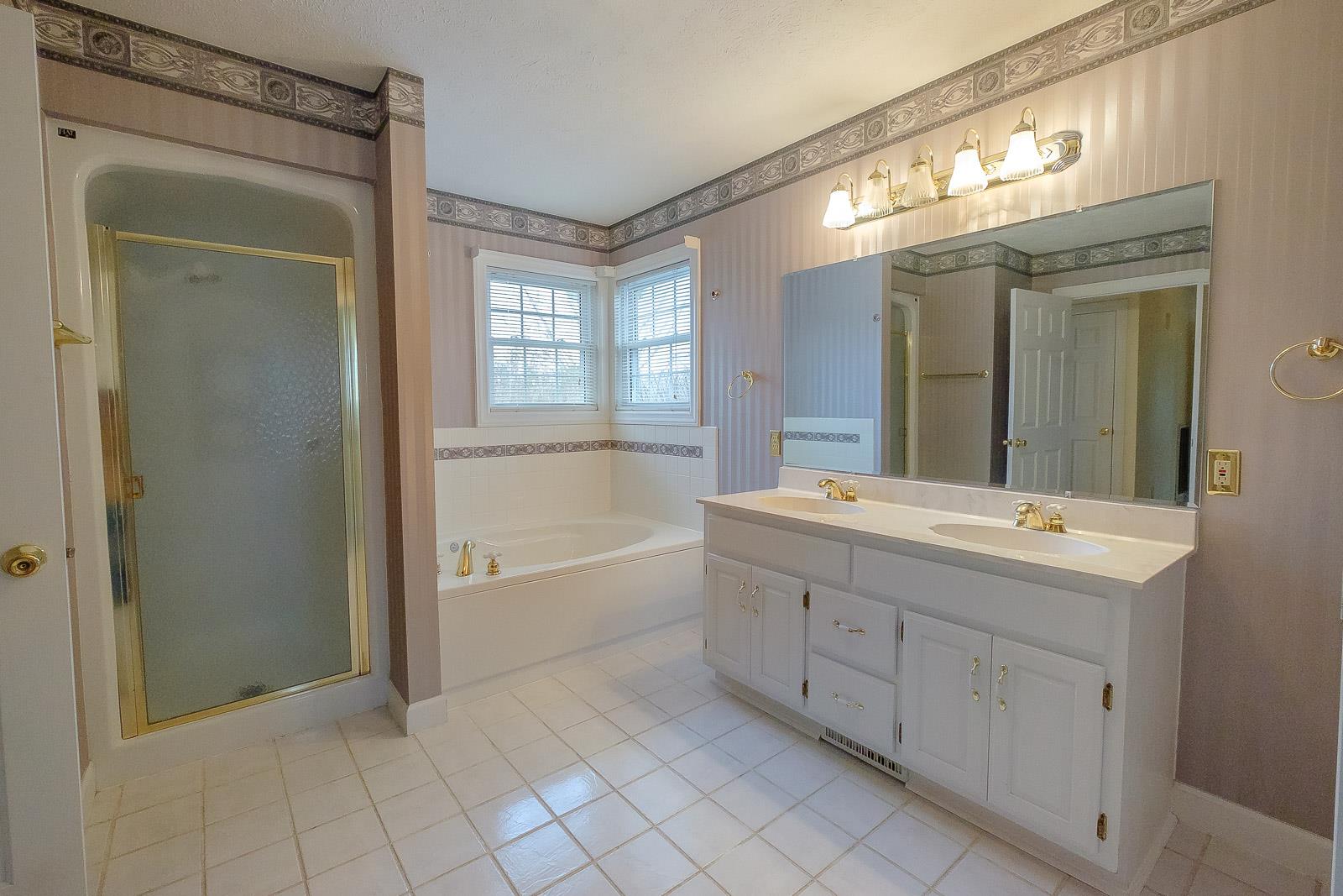 900 Red Boiling Springs Road Lafayette, TN 37083 - Photo 24 of 30 a spacious bathroom with a double vanity sink mirror and a bathtub