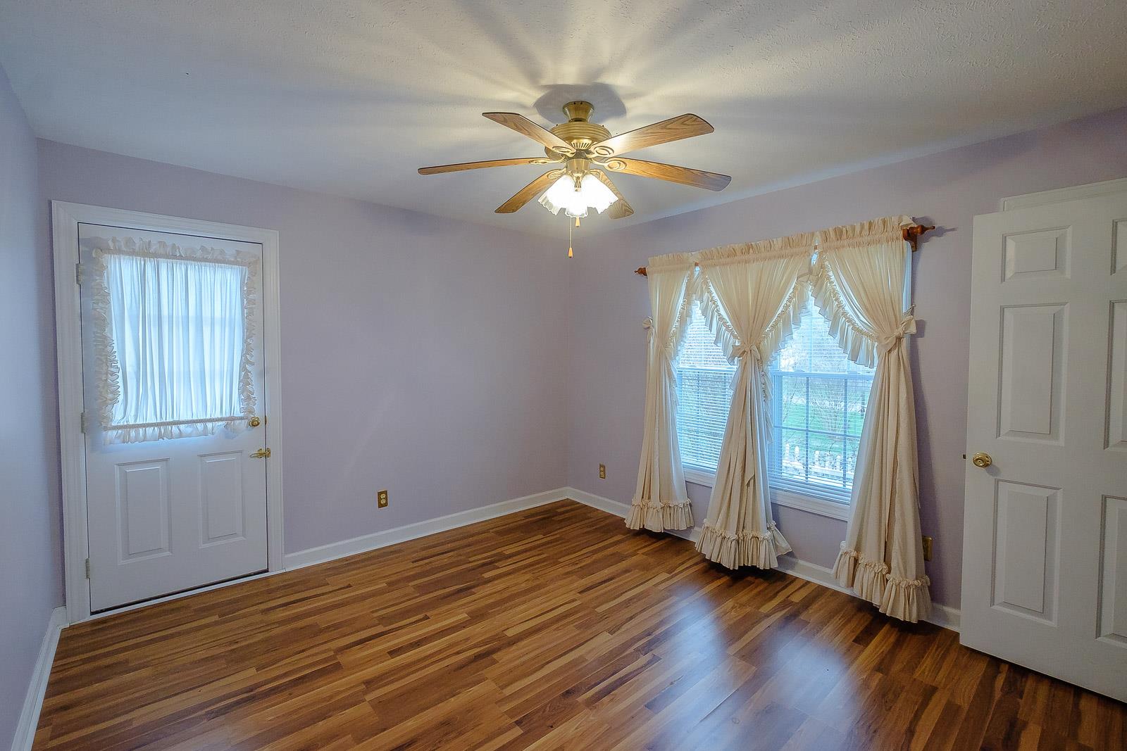900 Red Boiling Springs Road Lafayette, TN 37083 - Photo 25 of 30 an empty room with wooden floor fan and windows