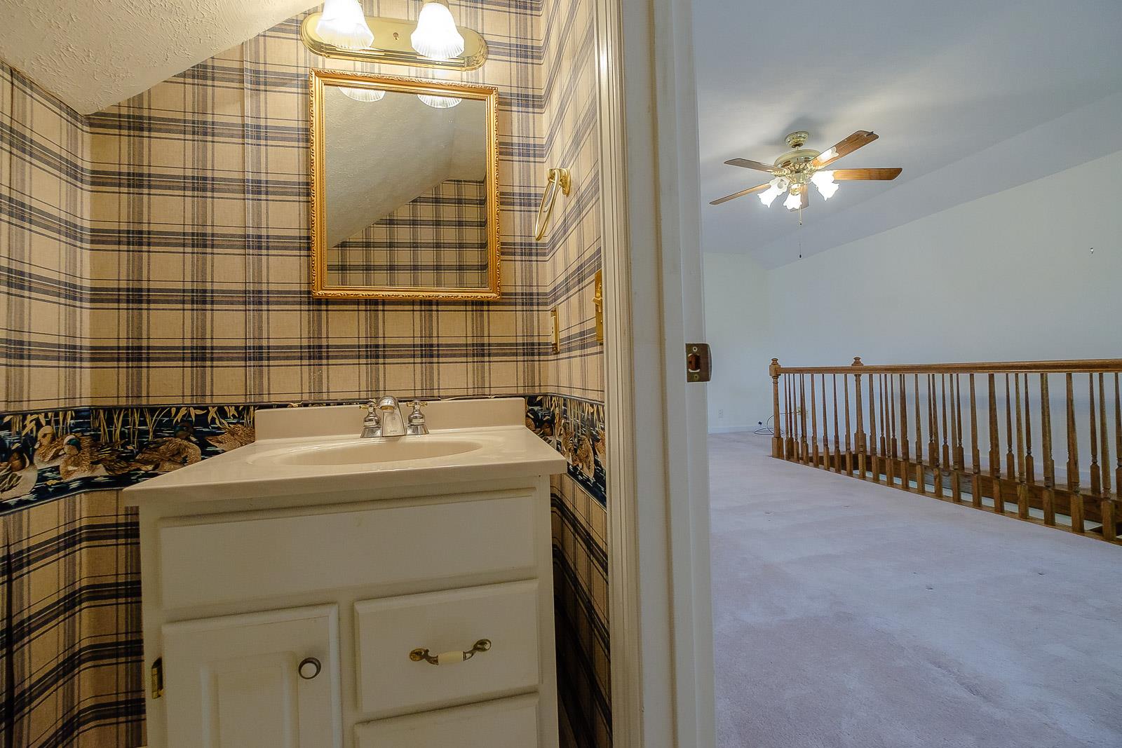 900 Red Boiling Springs Road Lafayette, TN 37083 - Photo 27 of 30 a bathroom with a sink and a mirror