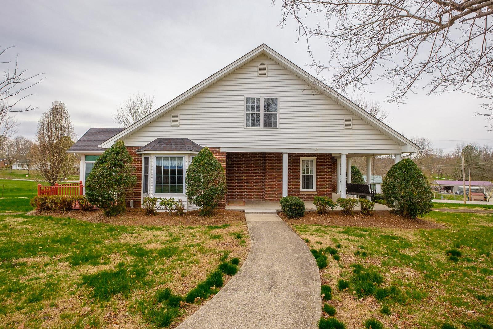 900 Red Boiling Springs Road Lafayette, TN 37083 - Photo 3 of 30 a front view of a house with a yard outdoor seating and pathway