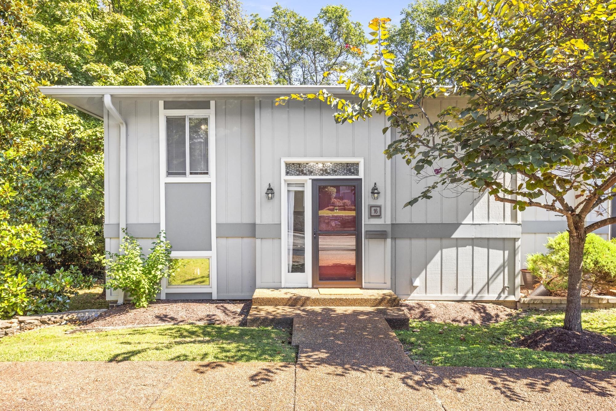 a front view of a house with a yard garage and outdoor seating