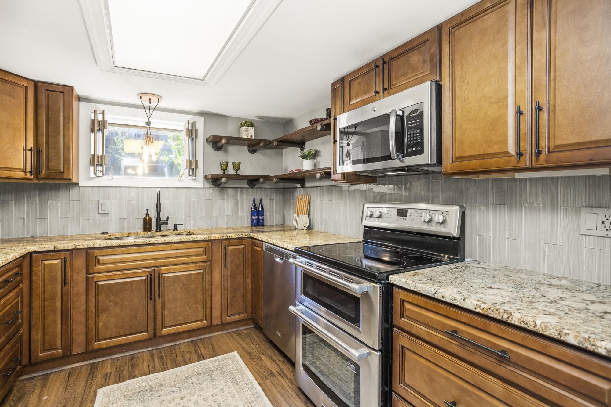 21 Vaughns Gap Road, Unit 16 Nashville, TN 37205 - Photo 12 of 34 a kitchen with stainless steel appliances granite countertop a sink and cabinets
