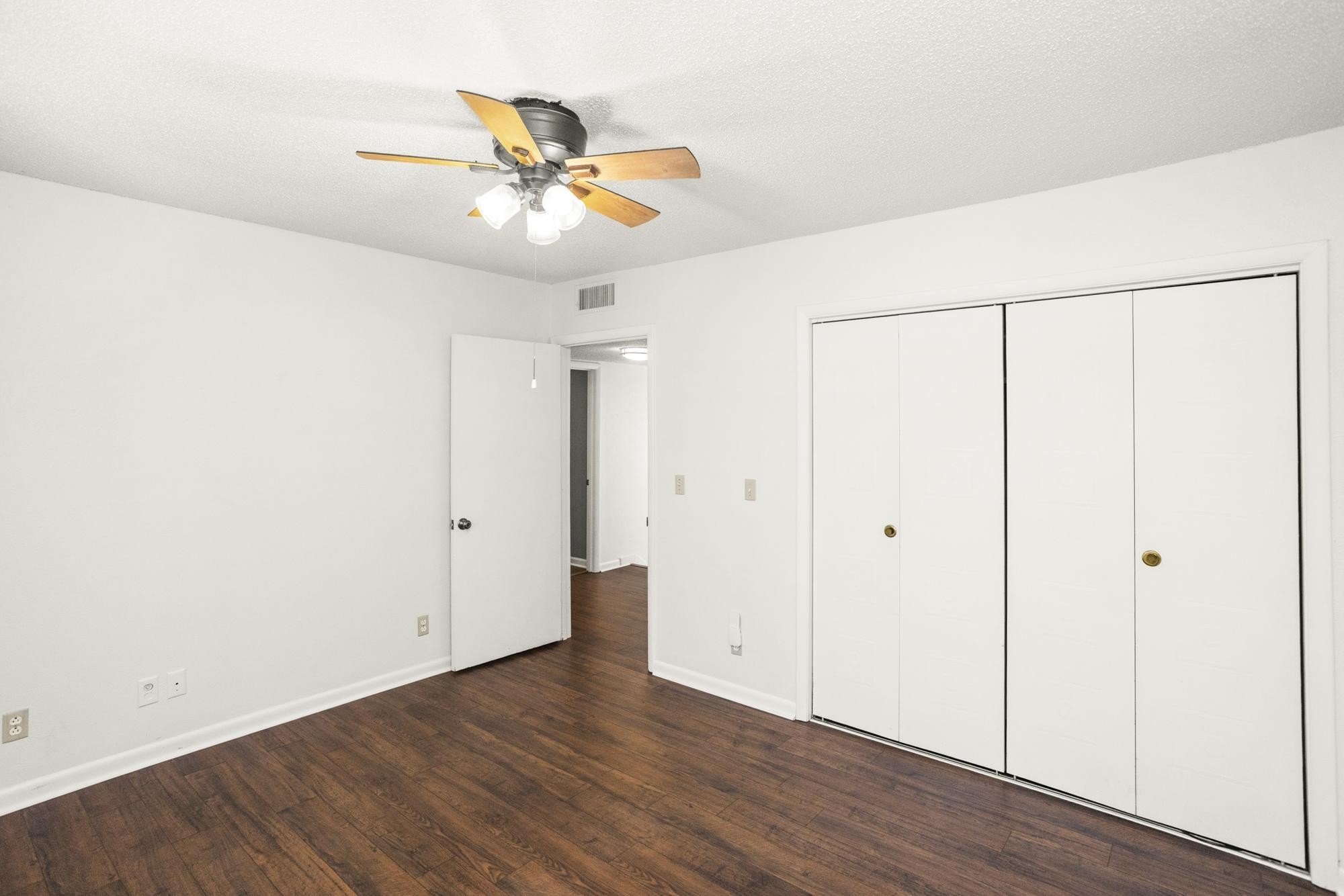 21 Vaughns Gap Road, Unit 16 Nashville, TN 37205 - Photo 21 of 34 an empty room with wooden floor closet and fan