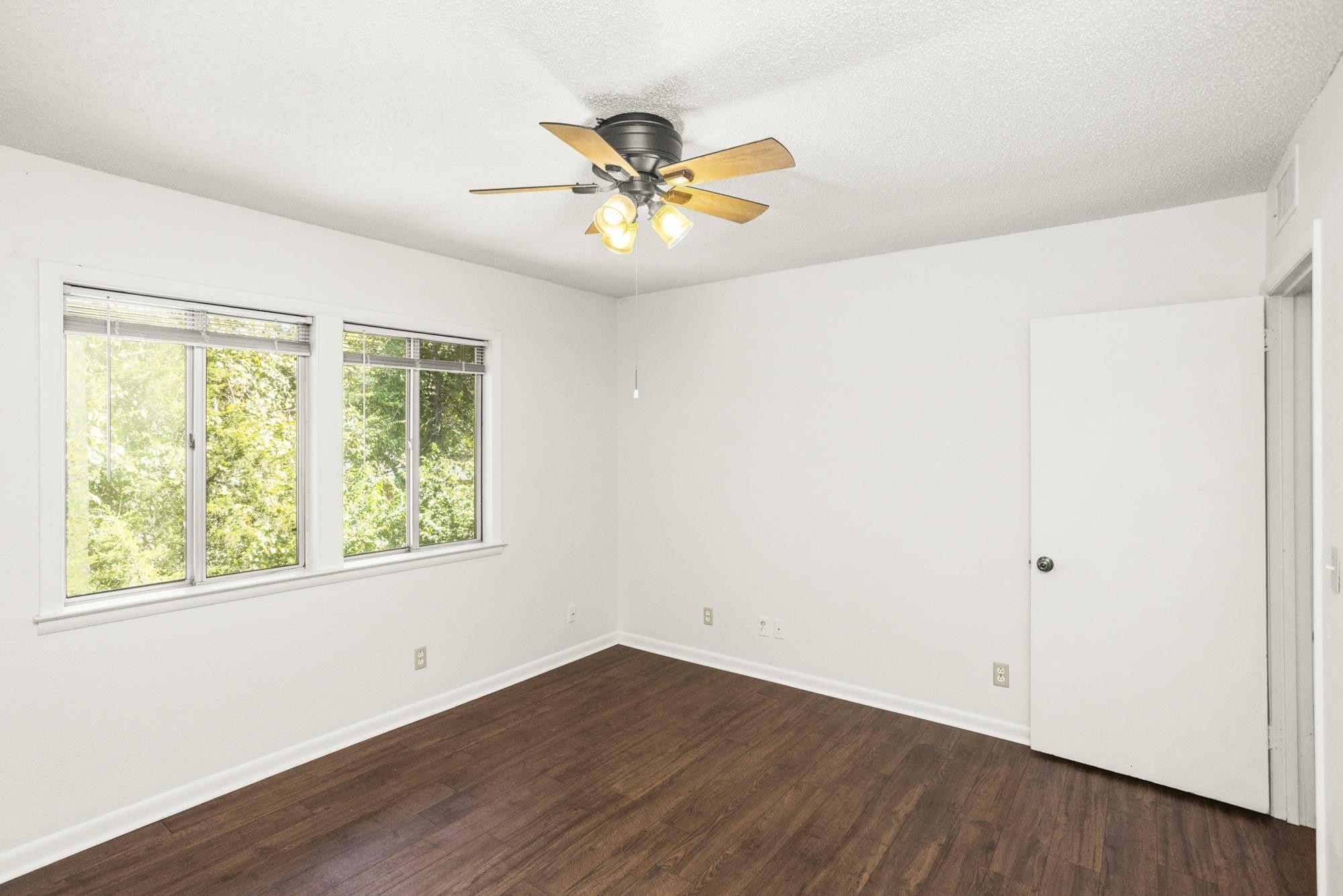 21 Vaughns Gap Road, Unit 16 Nashville, TN 37205 - Photo 22 of 34 a view of an empty room with wooden floor and a window
