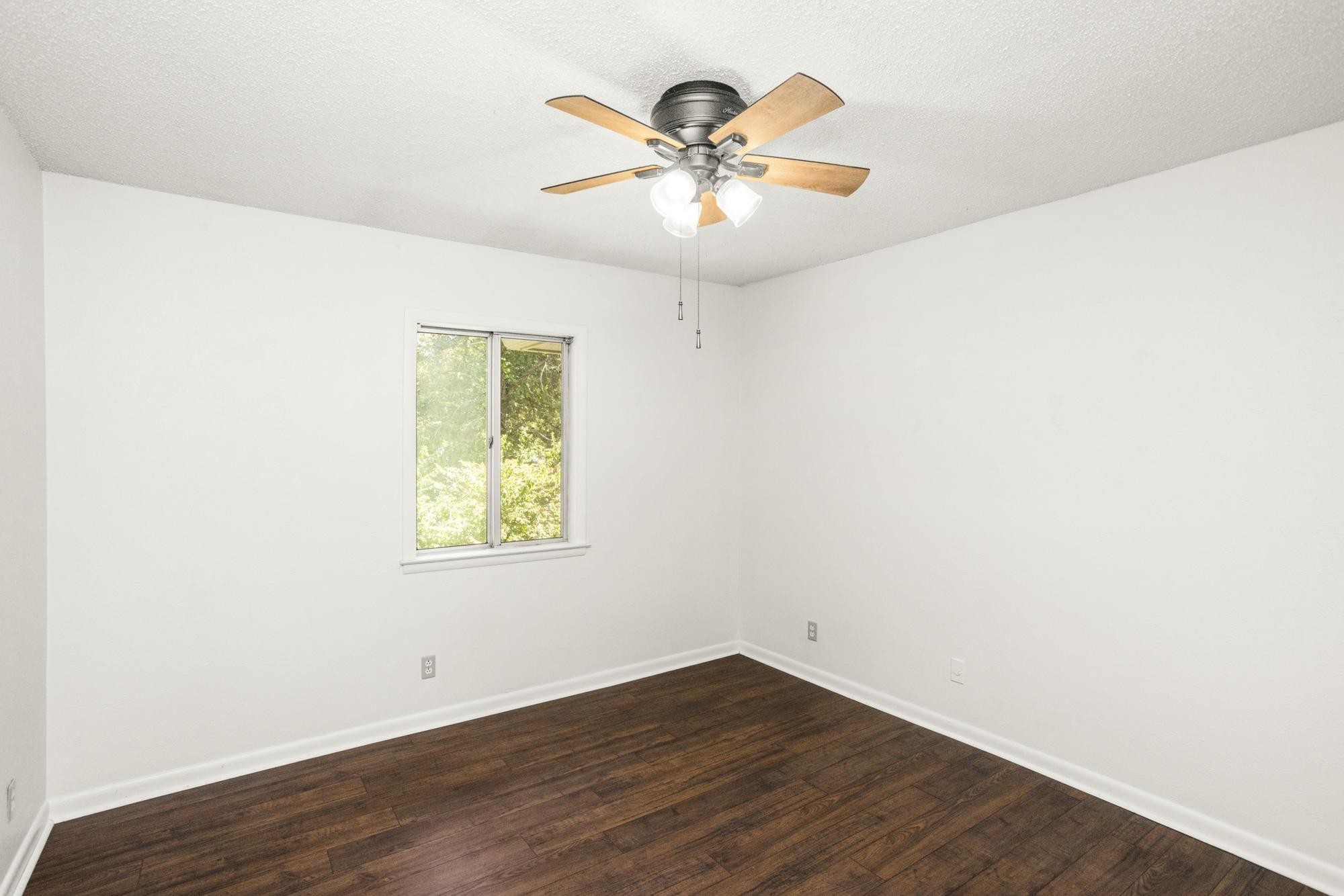 21 Vaughns Gap Road, Unit 16 Nashville, TN 37205 - Photo 23 of 34 an empty room with wooden floor and ceiling fan