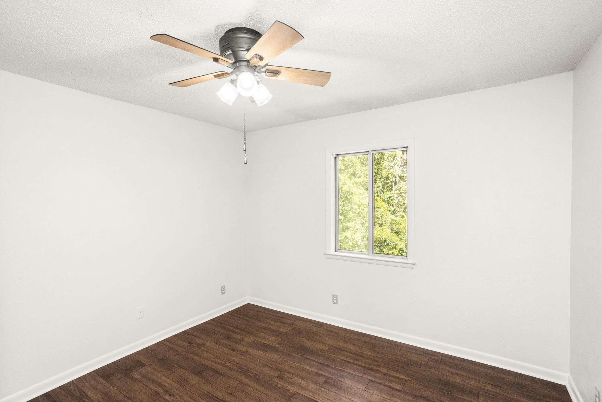 21 Vaughns Gap Road, Unit 16 Nashville, TN 37205 - Photo 24 of 34 an empty room with wooden floor fan and windows