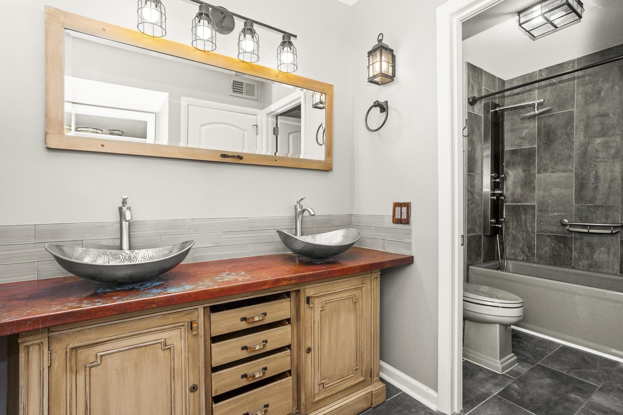 21 Vaughns Gap Road, Unit 16 Nashville, TN 37205 - Photo 27 of 34 a bathroom with a granite countertop sink a toilet and shower