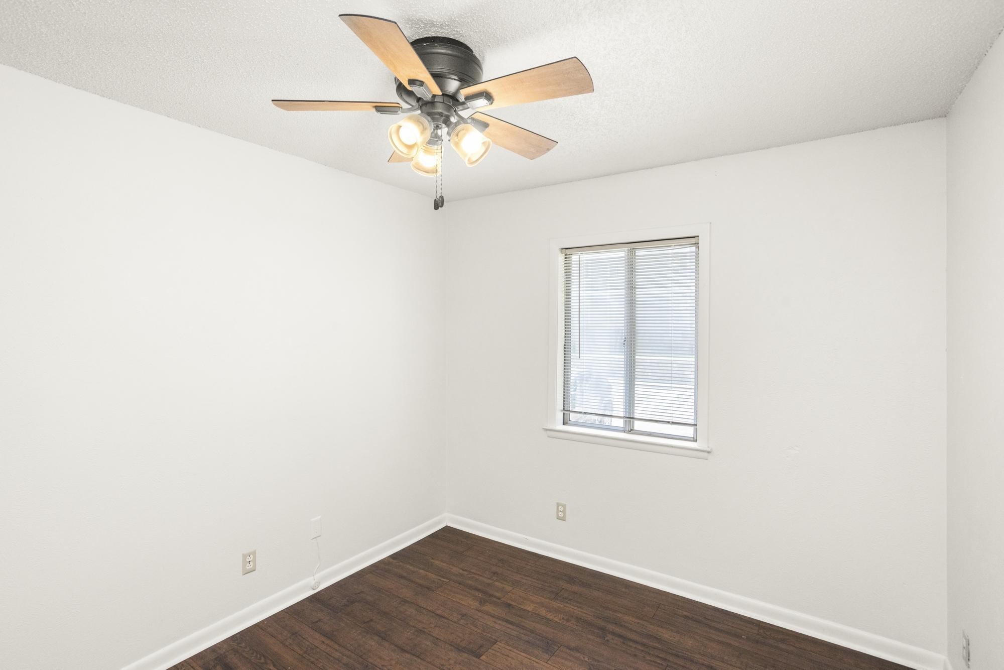 21 Vaughns Gap Road, Unit 16 Nashville, TN 37205 - Photo 30 of 34 an empty room with wooden floor and windows