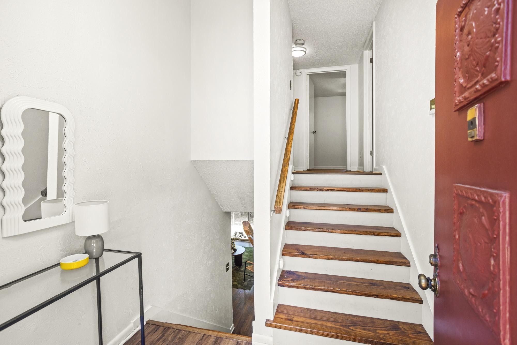 21 Vaughns Gap Road, Unit 16 Nashville, TN 37205 - Photo 4 of 34 a view of a hallway with wooden floor and furniture