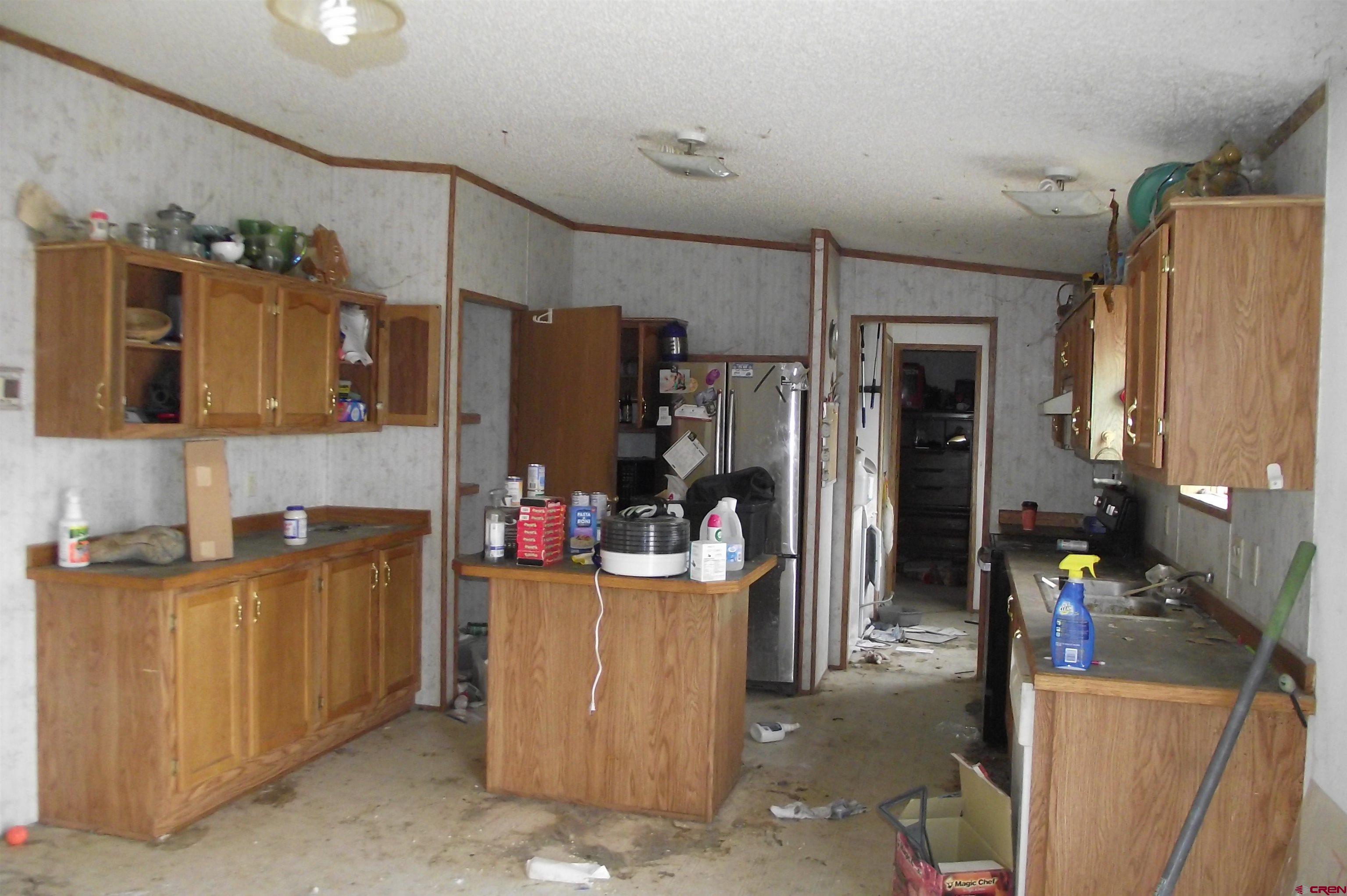 3747 2000th Road Delta, CO 81416 - Photo 11 of 24 a view of a kitchen with fridge and workspace