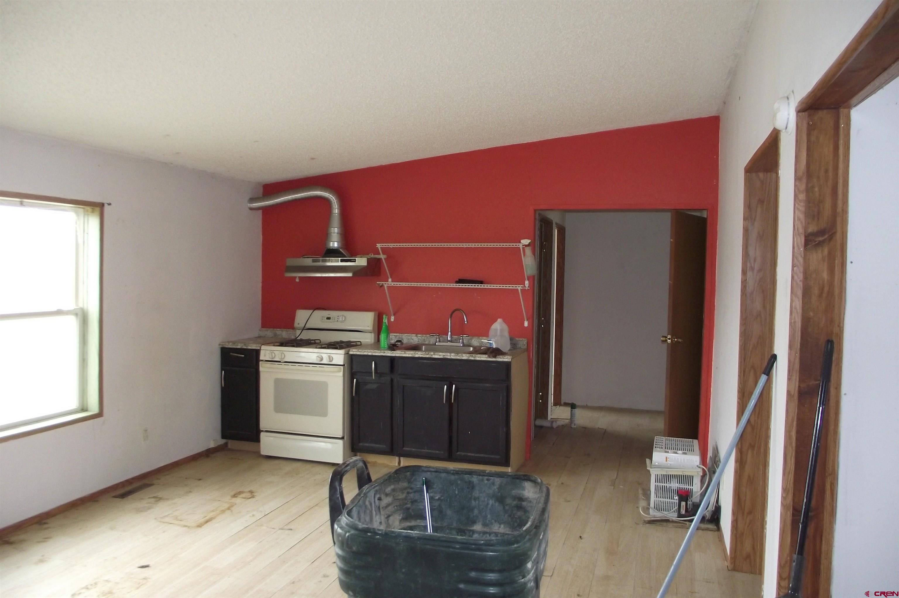 3747 2000th Road Delta, CO 81416 - Photo 17 of 24 a living room with stainless steel appliances kitchen island granite countertop a refrigerator and a stove
