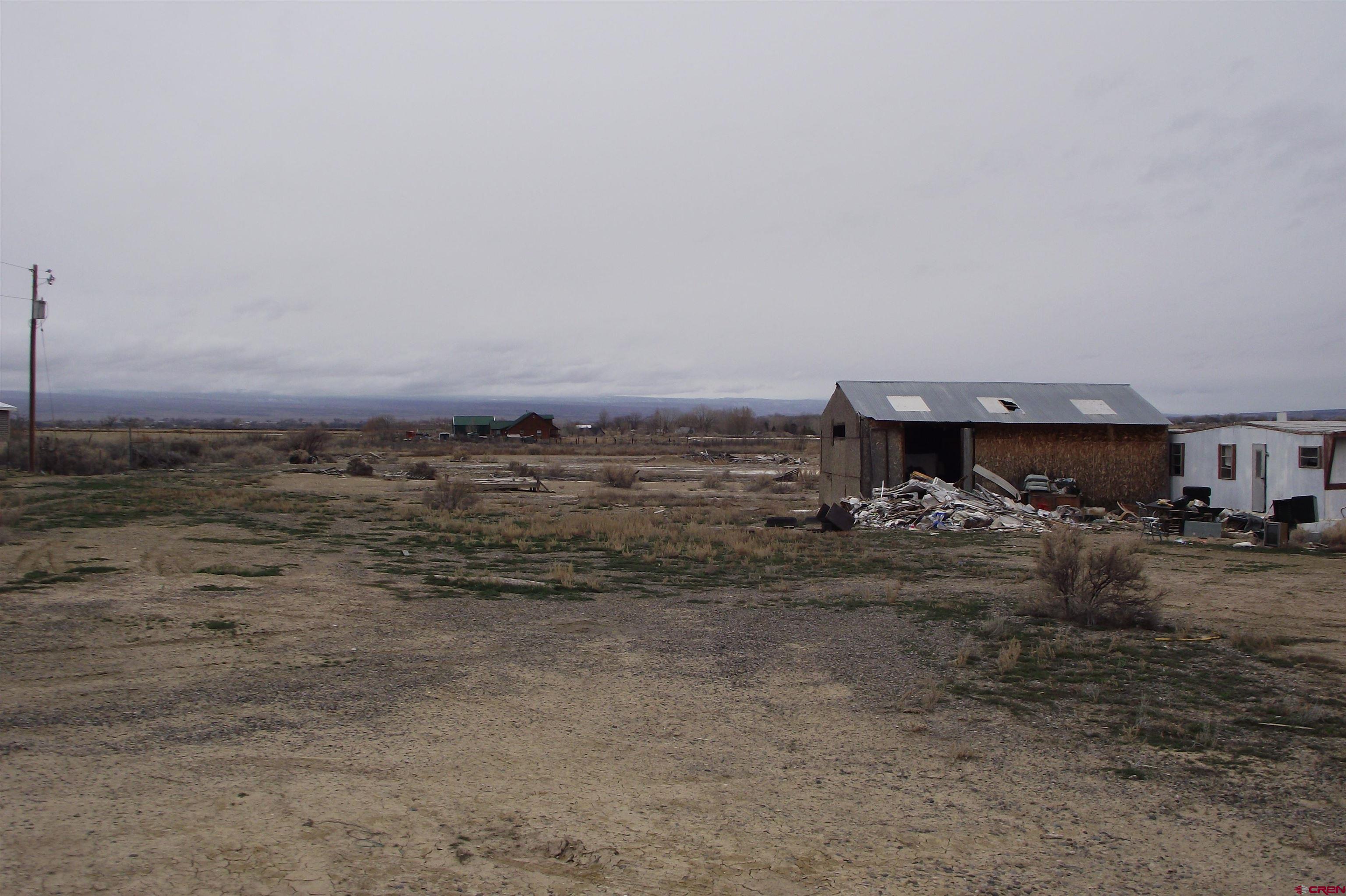 3747 2000th Road Delta, CO 81416 - Photo 4 of 24 a view of a dry yard with wooden fence