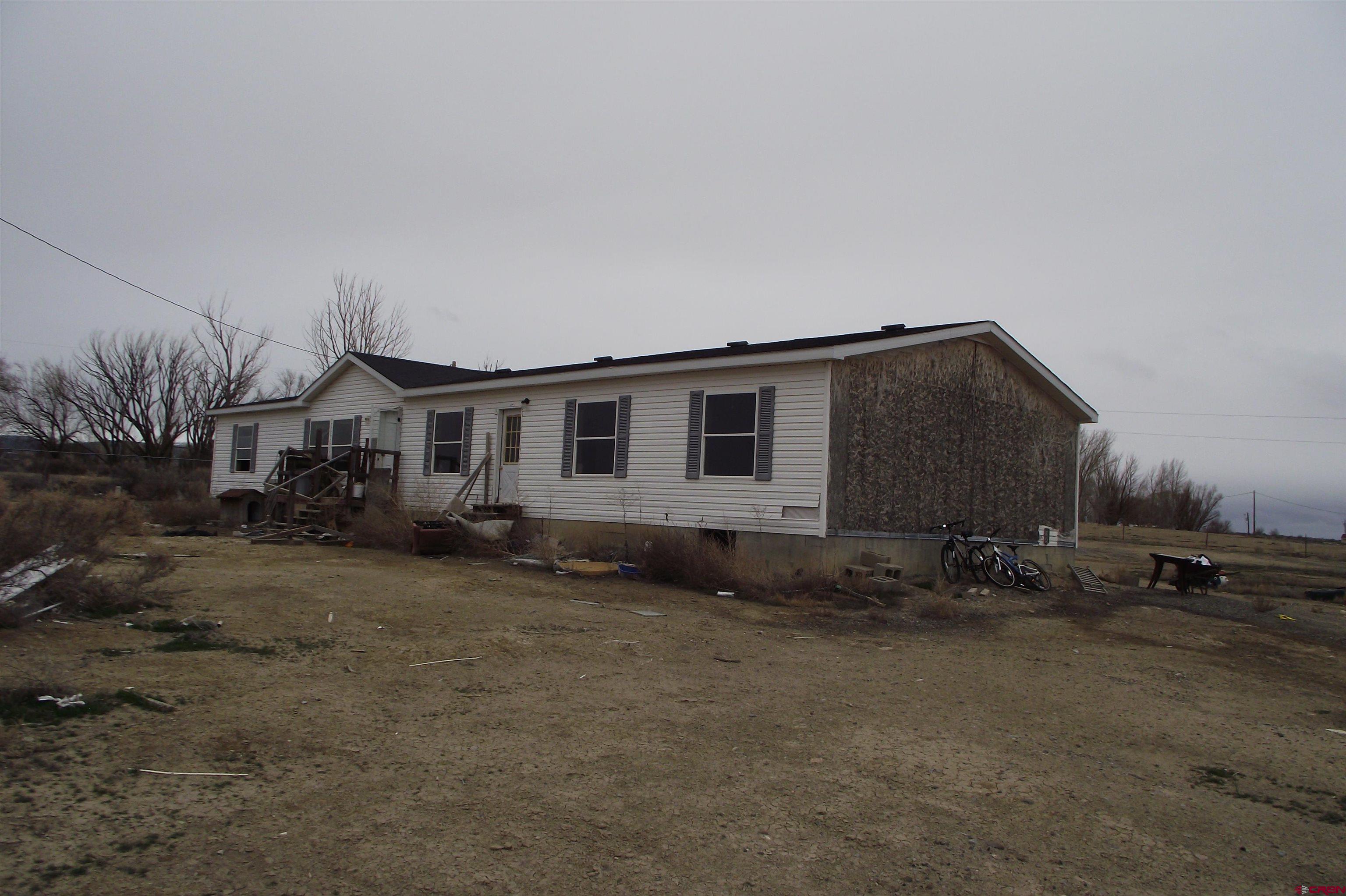 3747 2000th Road Delta, CO 81416 - Photo 8 of 24 a backyard of a house with wooden fence