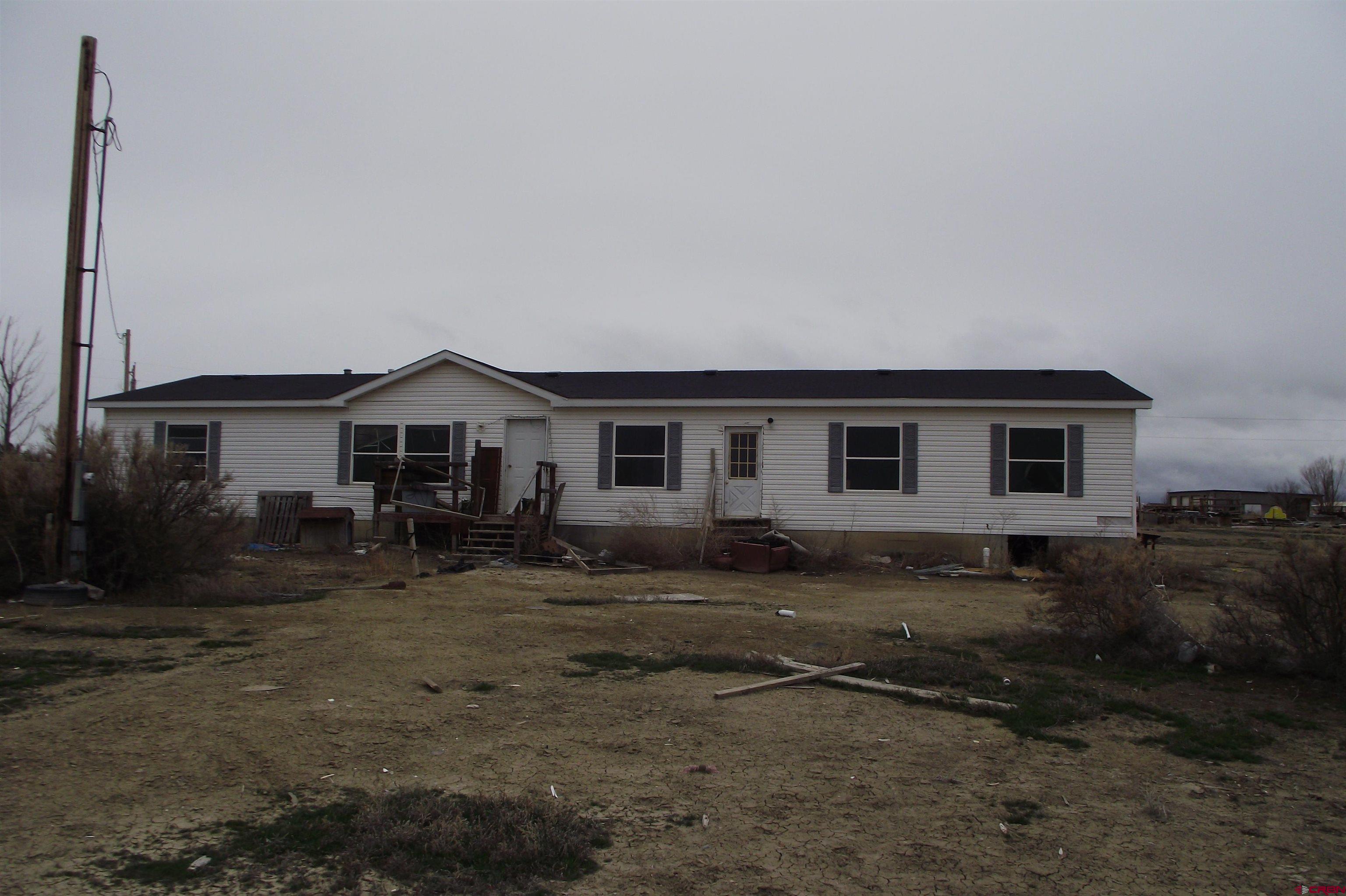 3747 2000th Road Delta, CO 81416 - Photo 9 of 24 a front view of a house with yard