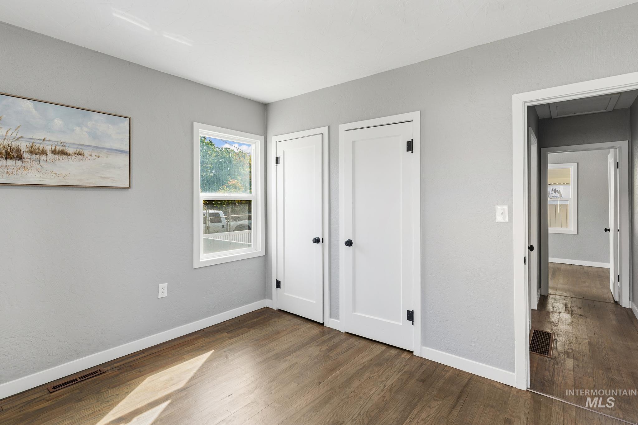 619 Thain Road Lewiston, ID 83501 - Photo 23 of 44 Interior room featuring wood-finish flooring, light gray walls, and white trim