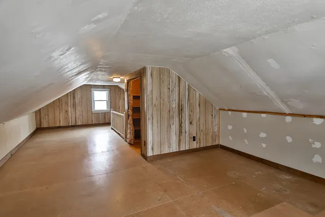 a view of a hallway with entryway and wooden floor
