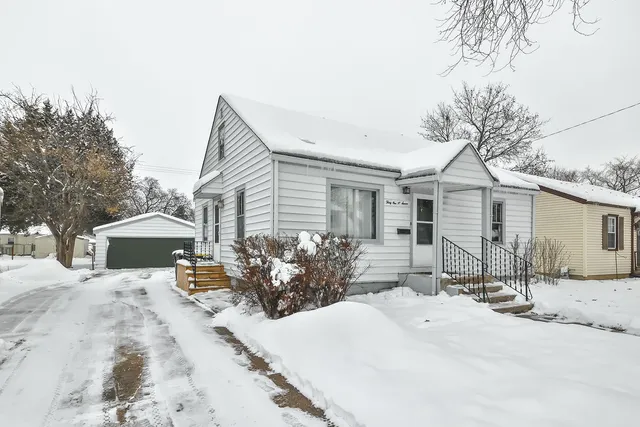 a front view of a house with a yard and seating space