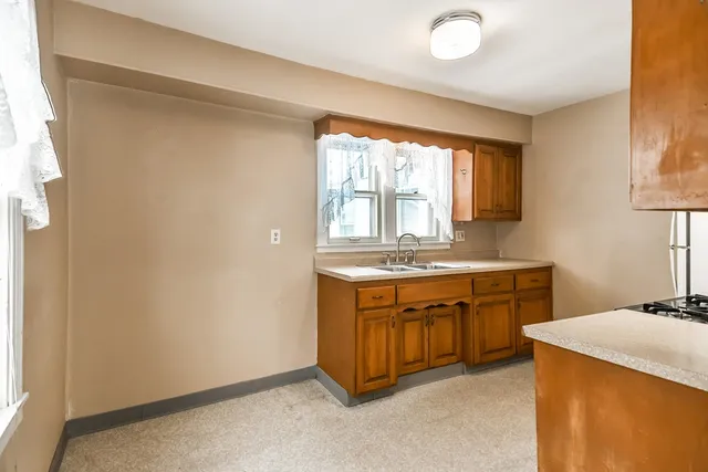 a spacious bathroom with a granite countertop sink and a bathtub