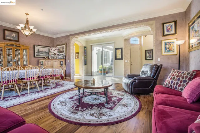 a living room with furniture and a chandelier