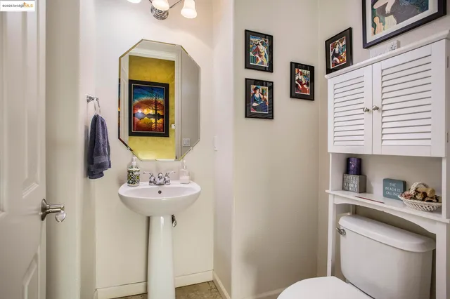 a bathroom with a sink mirror and toilet