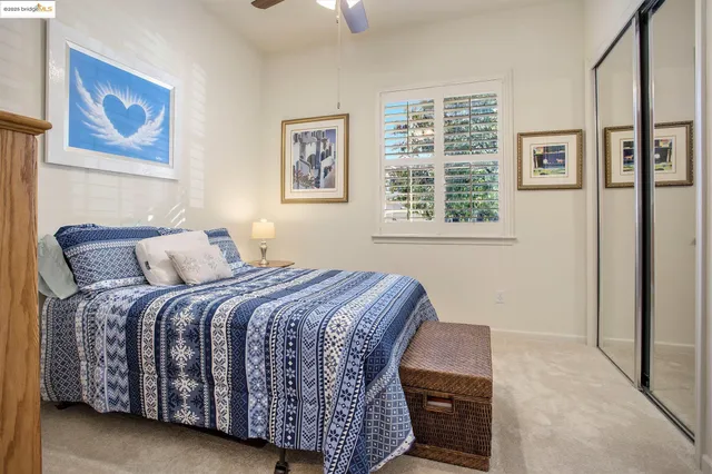 a bedroom with a bed lamp and a window