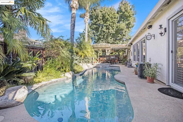 a view of a swimming pool with sitting area