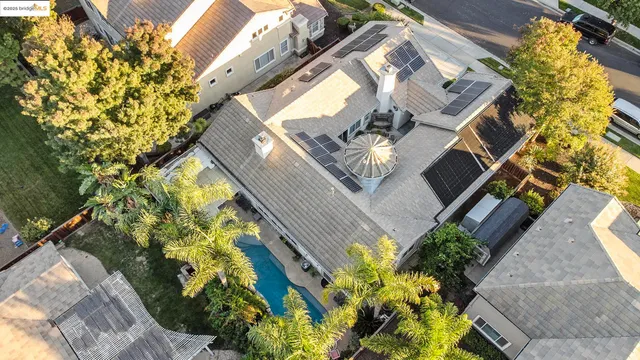an aerial view of a house with a yard and garden