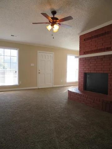 a view of empty room with a fireplace