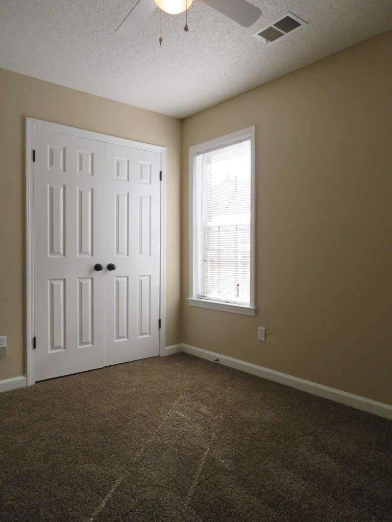 4207 Hickory Grove Road Memphis, TN 38141 - Photo 7 of 7 an empty room with windows