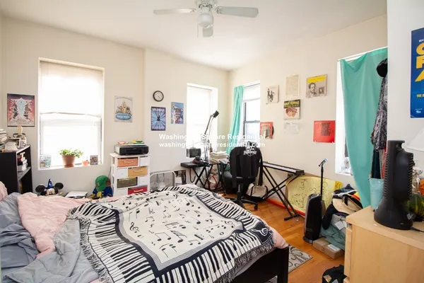 a bedroom with furniture a bed and a flat screen tv