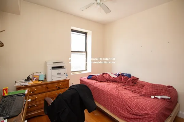 a bedroom with a bed and window