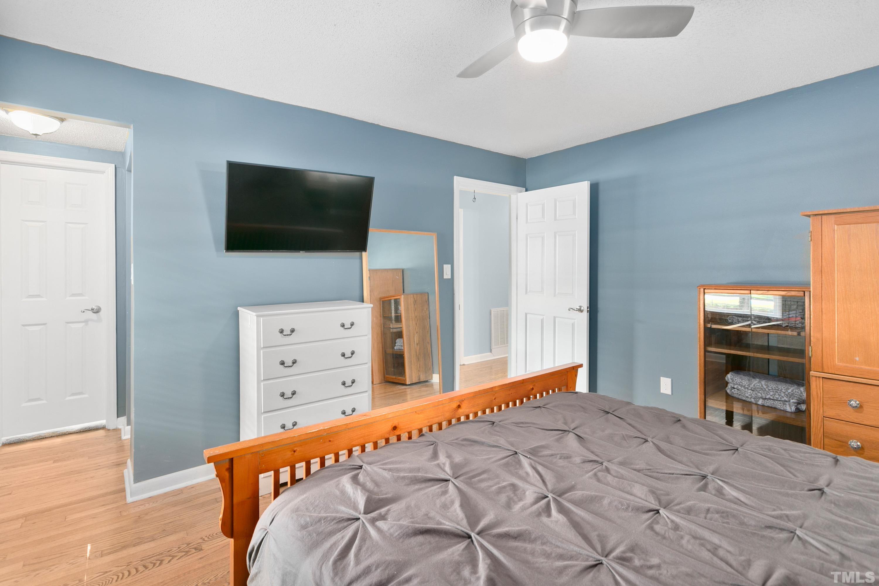 3702 Randell Road Garner, NC 27529 - Photo 14 of 24 a bedroom with a bed and flat screen tv