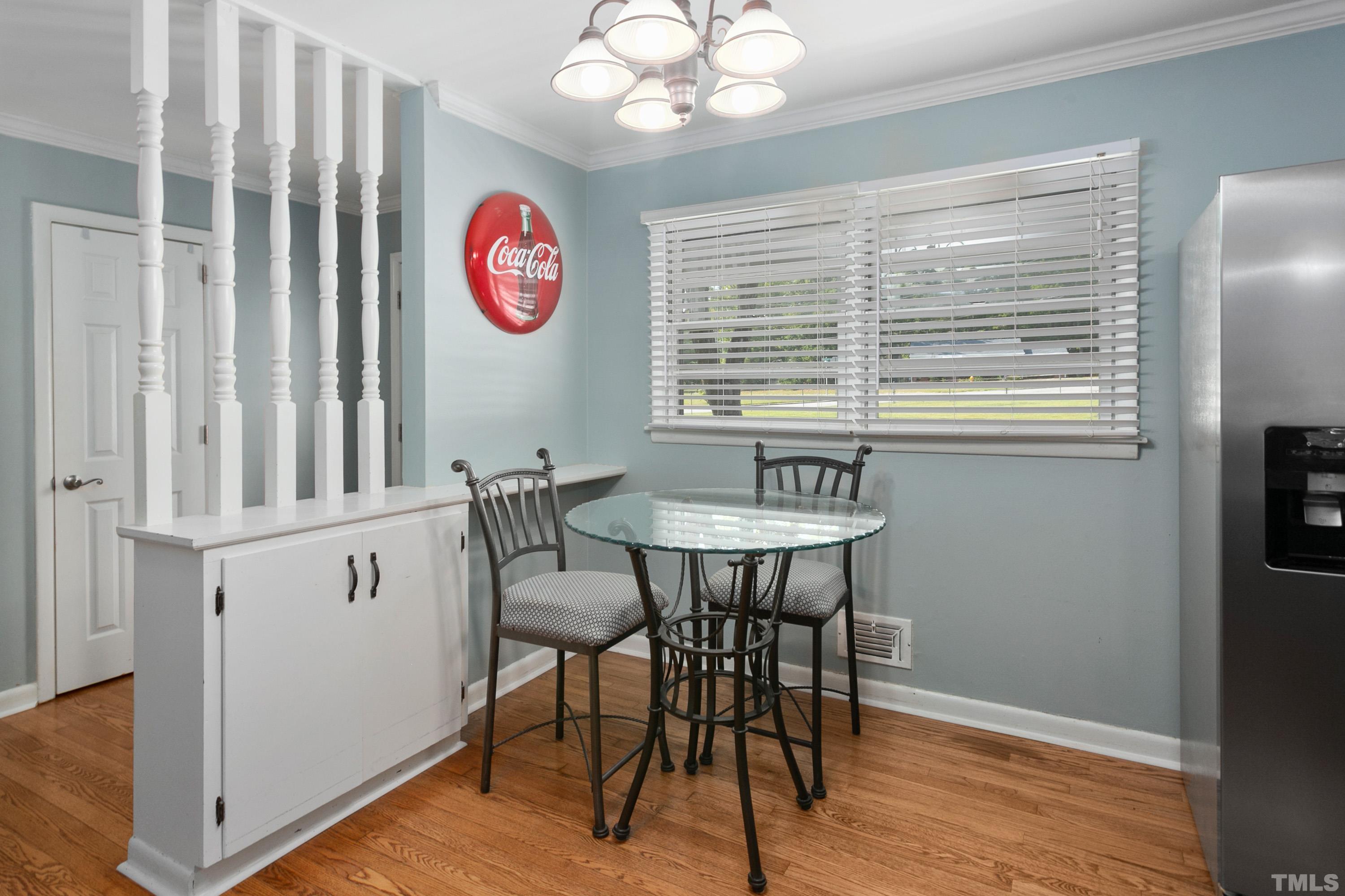3702 Randell Road Garner, NC 27529 - Photo 6 of 24 a view of a dining room with furniture window and wooden floor