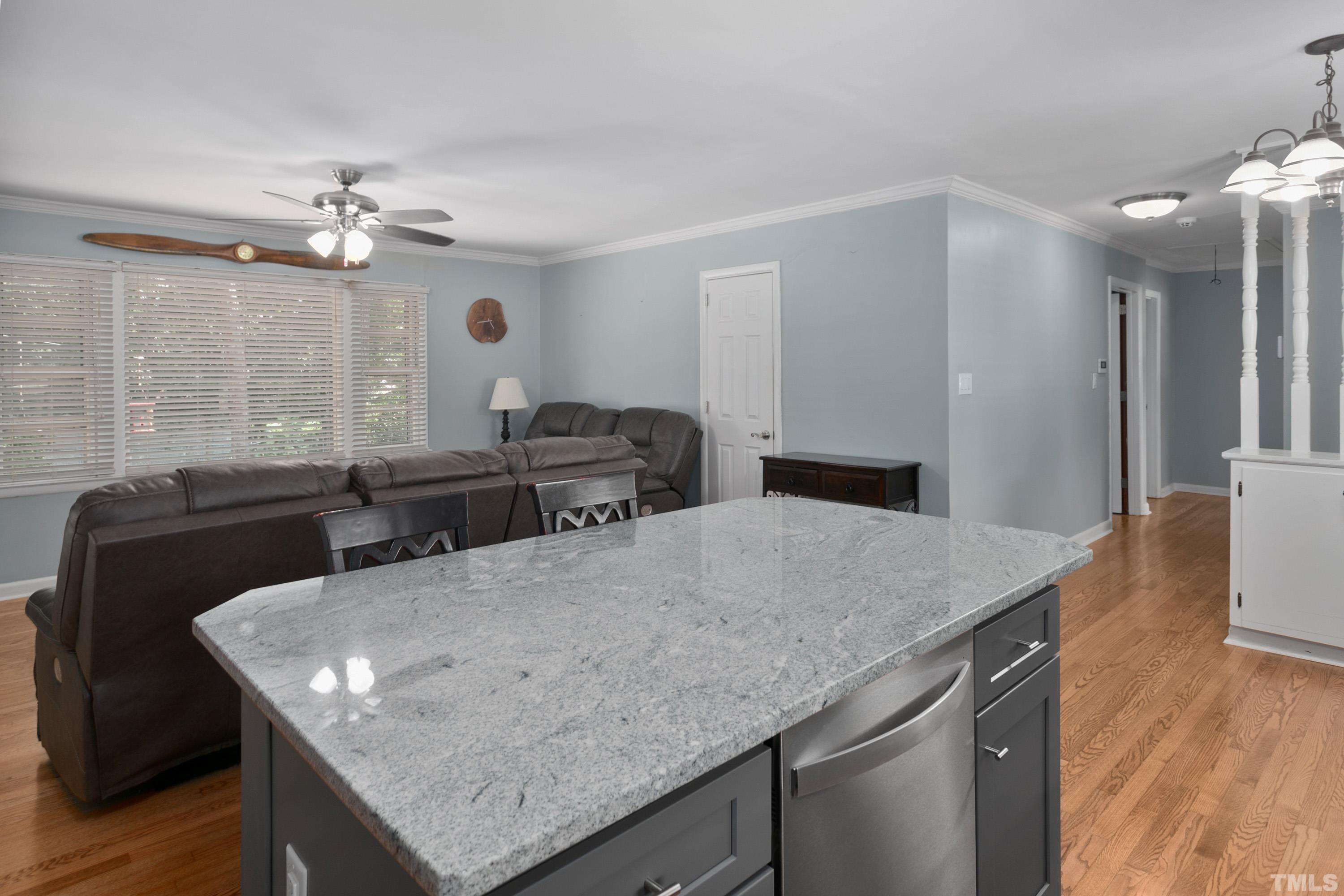 3702 Randell Road Garner, NC 27529 - Photo 10 of 24 a kitchen with granite countertop cabinets table and chairs