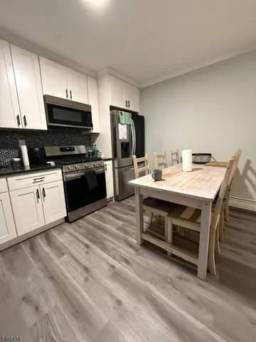 a kitchen with a stove sink and microwave