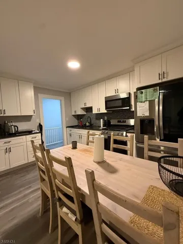 a kitchen with kitchen island a counter top space appliances and cabinets