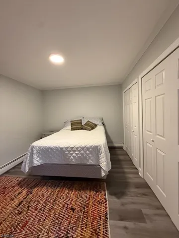 a bed sitting in a spacious bedroom next to a window