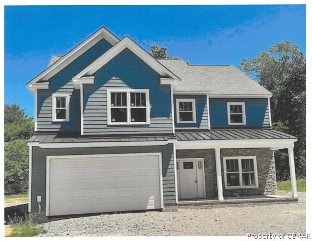 View of front of property featuring a garage