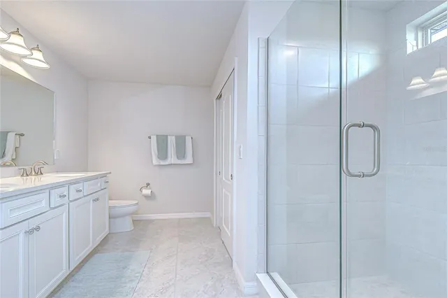 a living room with furniture a flat screen tv and a window