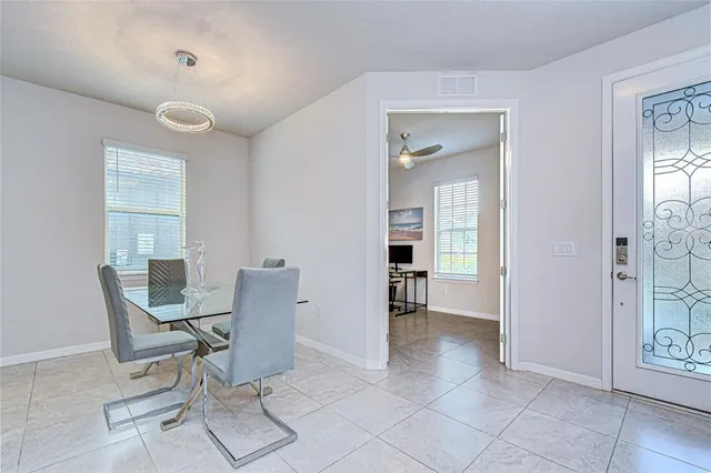 a dining room with furniture and window