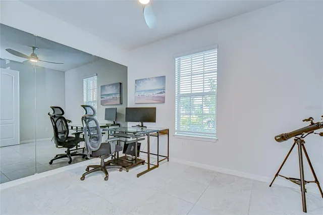 a view of a workspace with furniture and a window