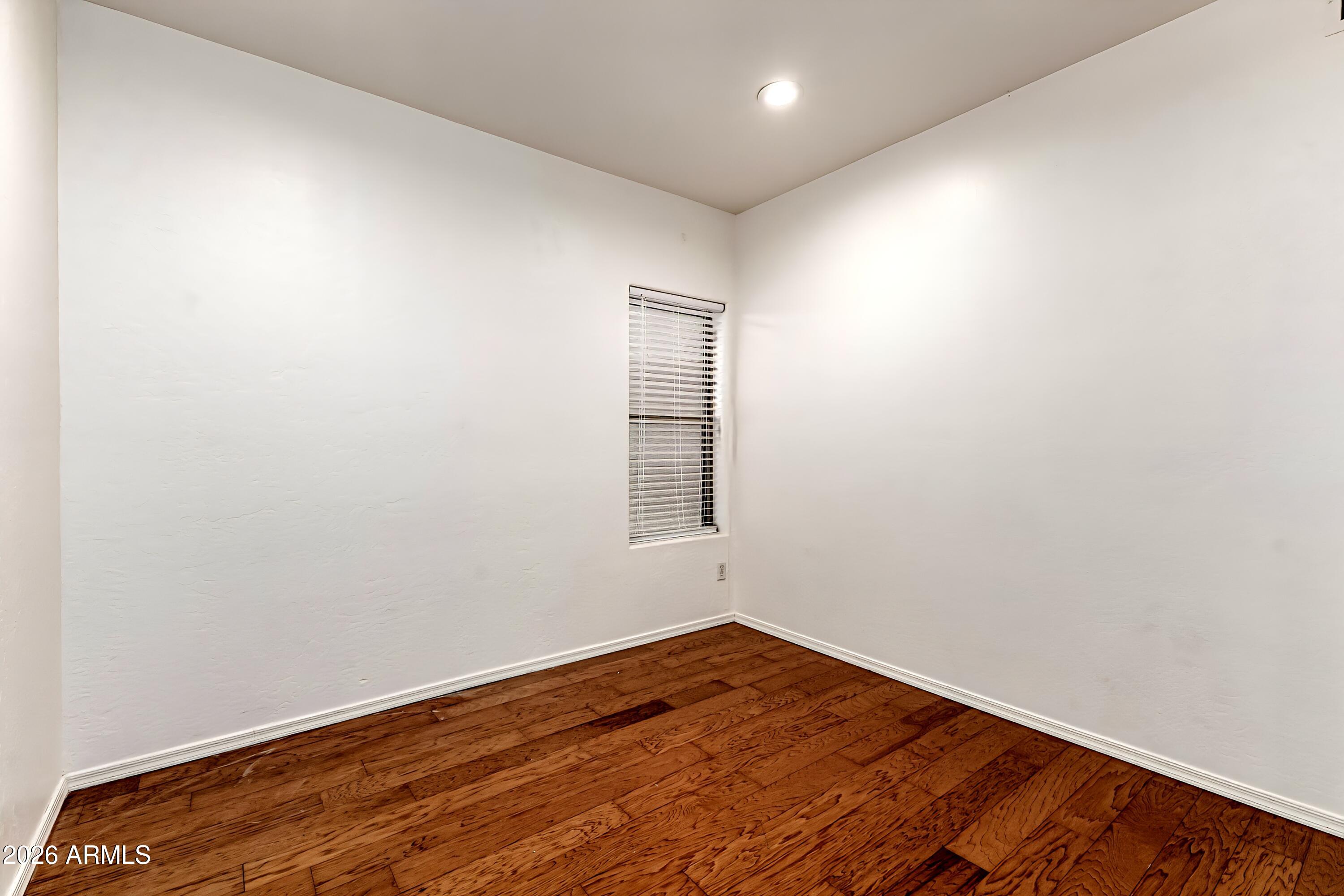 4208 South Sawmill Road Gilbert, AZ 85297 - Photo 34 of 46 an empty room with wooden floor and windows