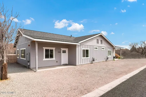 a view of a house with a yard and garage